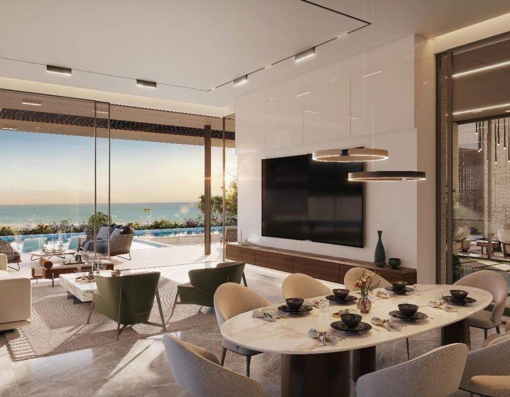 Living and dining areas opening onto the pool and waterfront